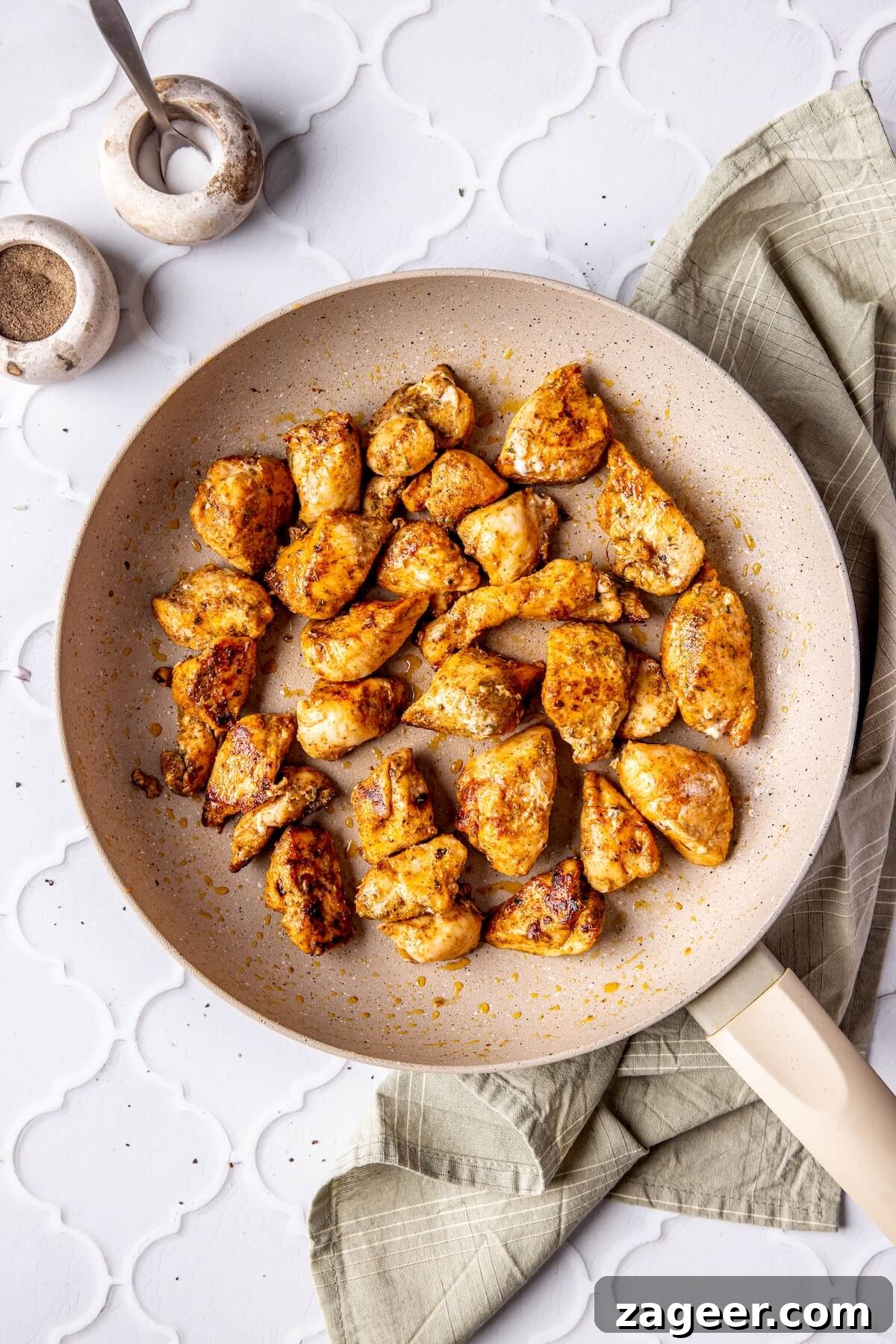 Ultimate Greek Chicken Bowl with Zesty Dairy-Free Tzatziki 13 Step 6: Chicken cubes cooking in a non-stick skillet until golden brown.