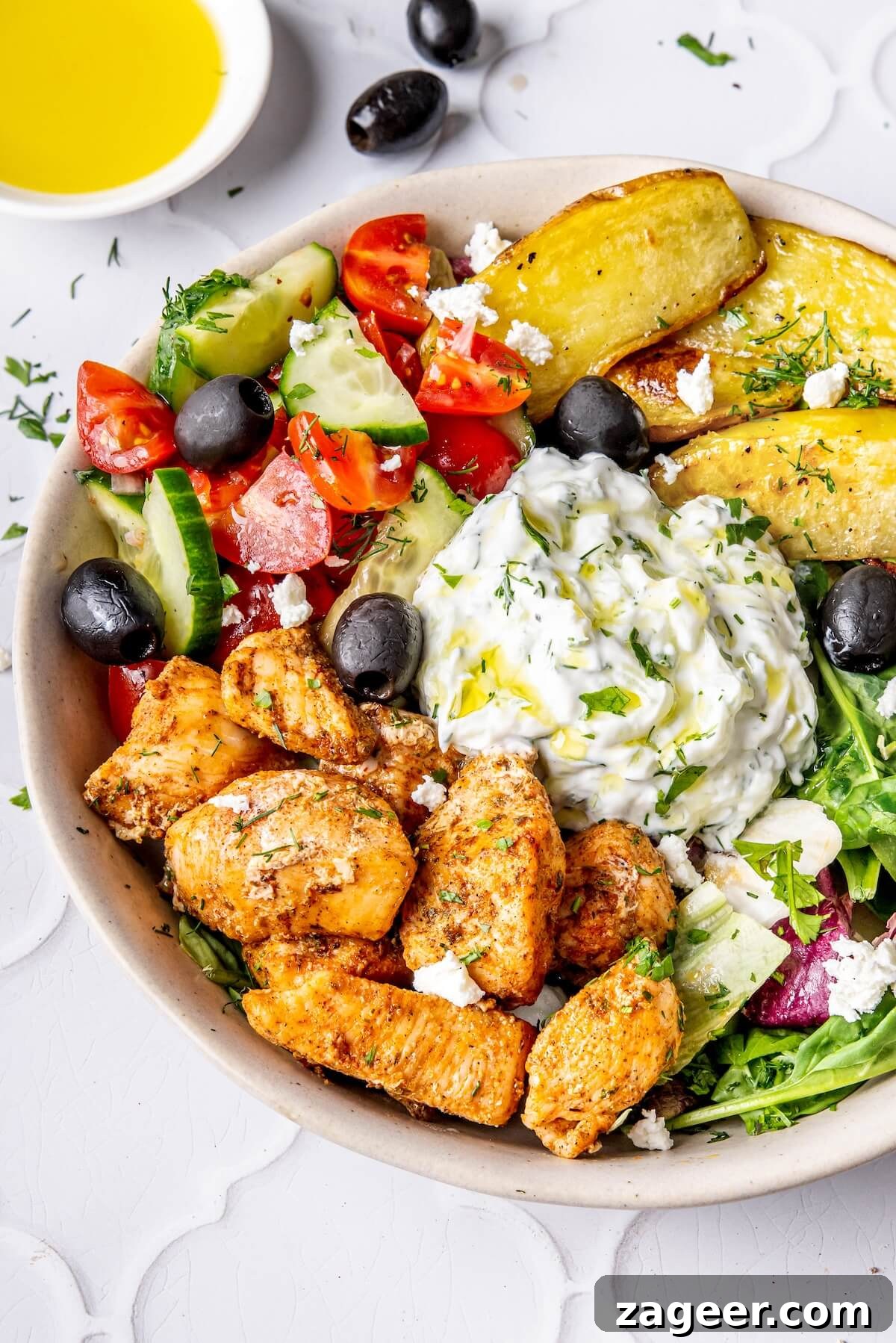 Ultimate Greek Chicken Bowl with Zesty Dairy-Free Tzatziki 4 Close-up of a Loaded Greek Chicken Bowl with Dairy-Free Tzatziki, showing texture and detail of the fresh ingredients.