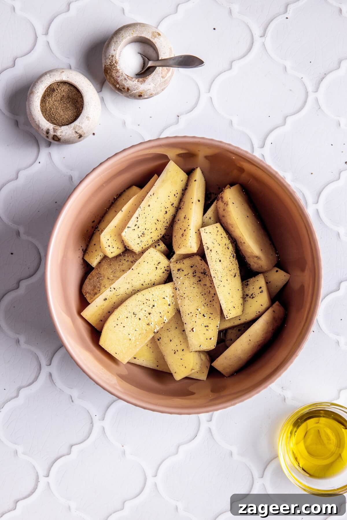 Ultimate Greek Chicken Bowl with Zesty Dairy-Free Tzatziki 8 Step 1: Sweet potato wedges tossed with oil and seasoning, ready for roasting.