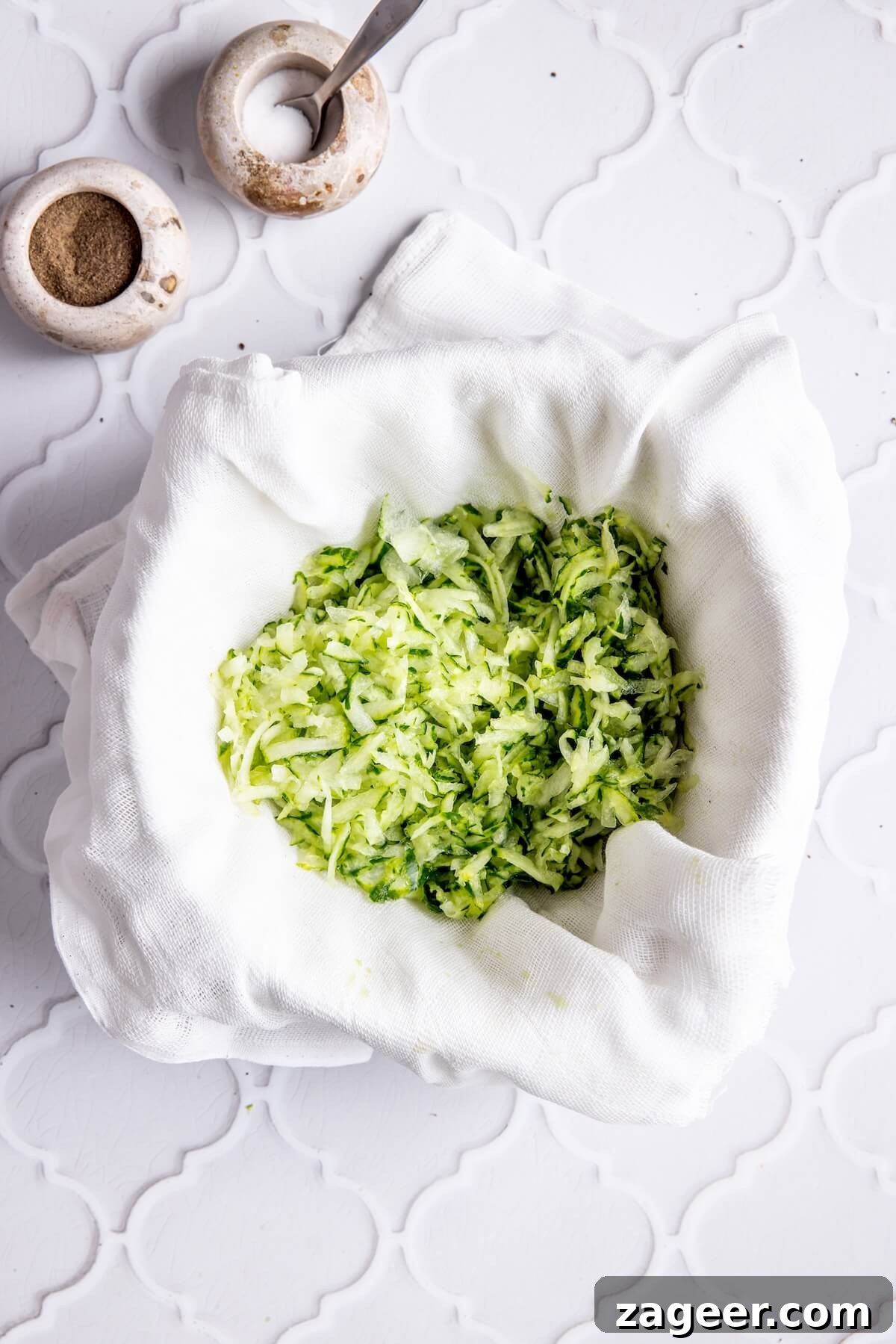 Ultimate Greek Chicken Bowl with Zesty Dairy-Free Tzatziki 9 Step 2: Shredded cucumber being squeezed to remove excess liquid for tzatziki.