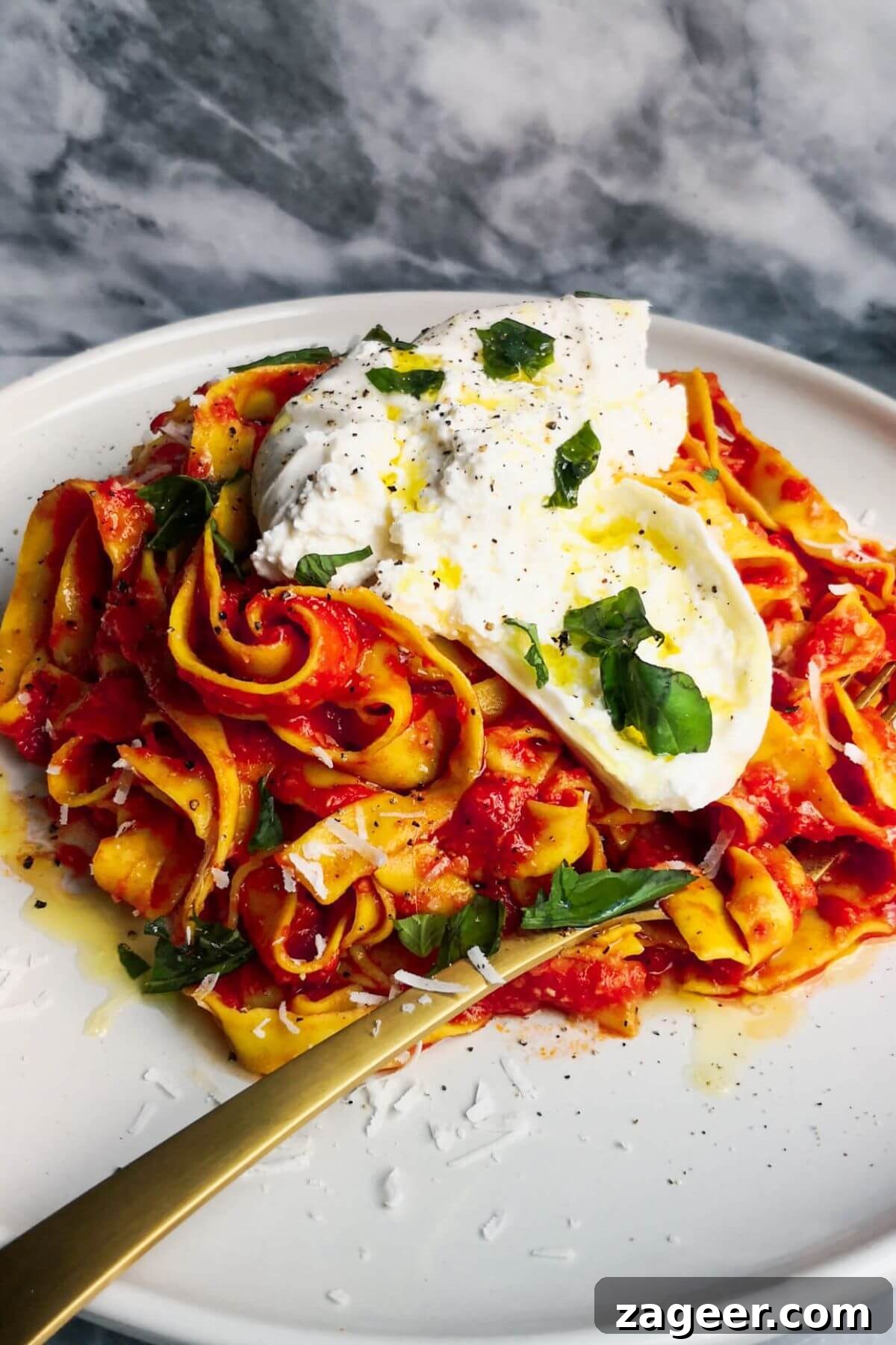 Quick Spicy Nduja Pasta with Creamy Burrata 2 Spicy nduja pasta on a white plate with a ball of burrata on top, ready to be enjoyed.