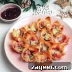 Close-up of a single Brie, Cranberry, and Prosciutto Filo Bite, highlighting the golden crispy pastry and melted cheese, perfect for a party.