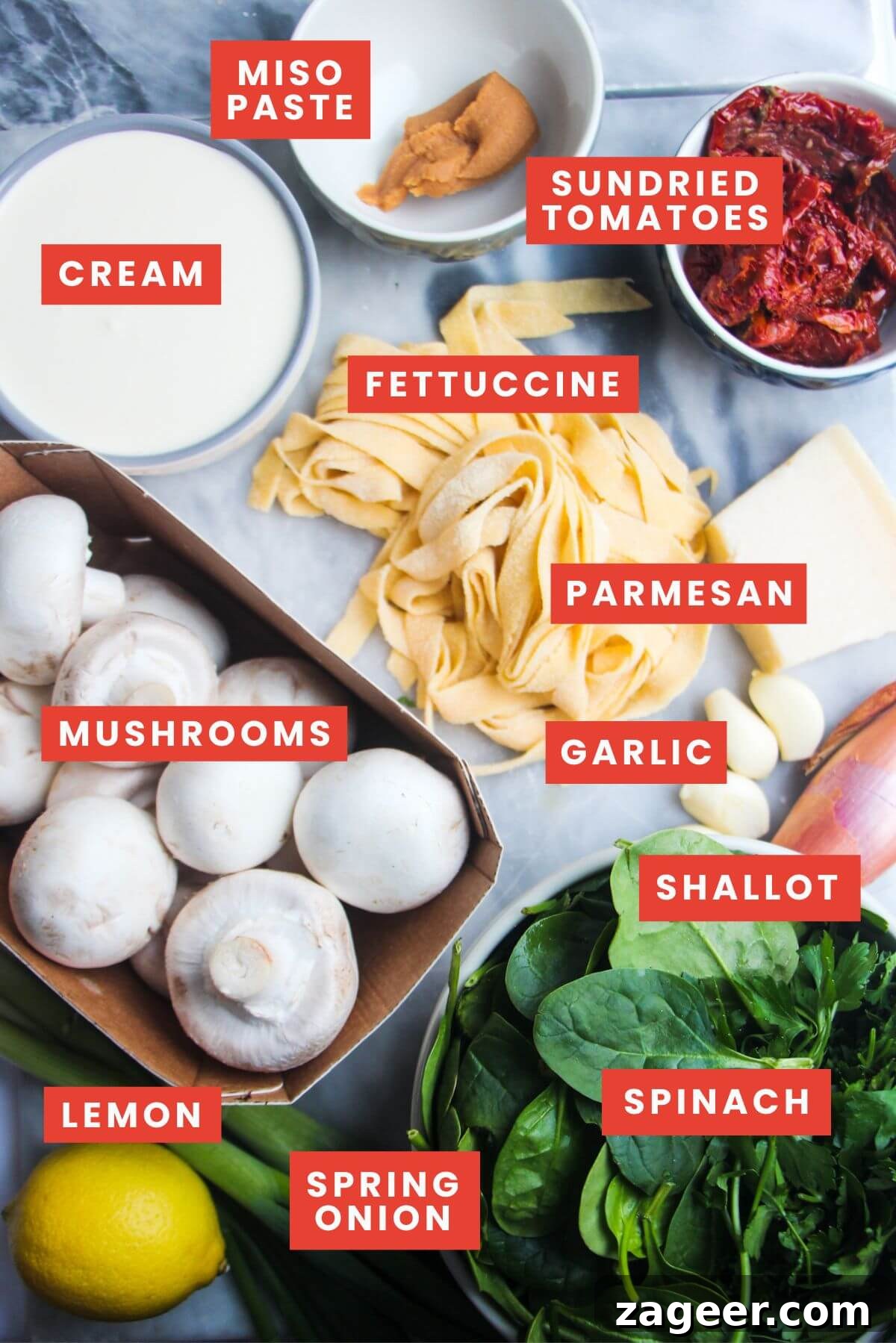 Creamy Miso Mushroom Fettuccine Alfredo 3 Carefully arranged ingredients for creamy mushroom fettuccine alfredo on a grey marble background, ready for preparation.