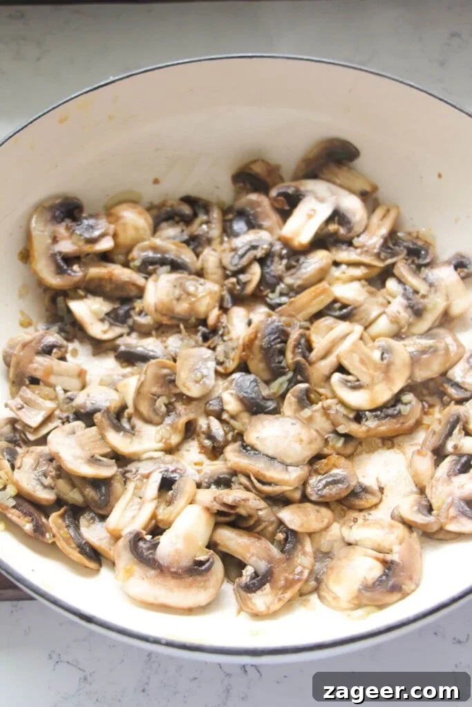 Velvety One-Pot Mushroom Orzo 4 Mushrooms cooked in a white skillet.