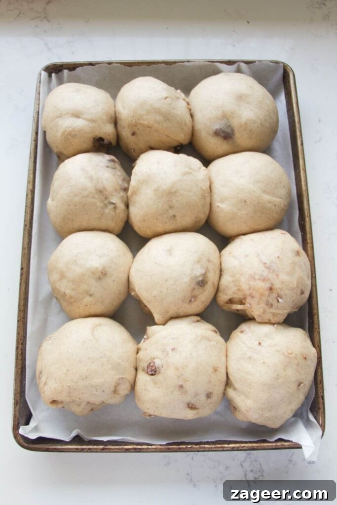 Easter Mini Egg Chocolate Hot Cross Buns 11 12 mini egg hot cross buns after rising in a baking paper lined oven tray.