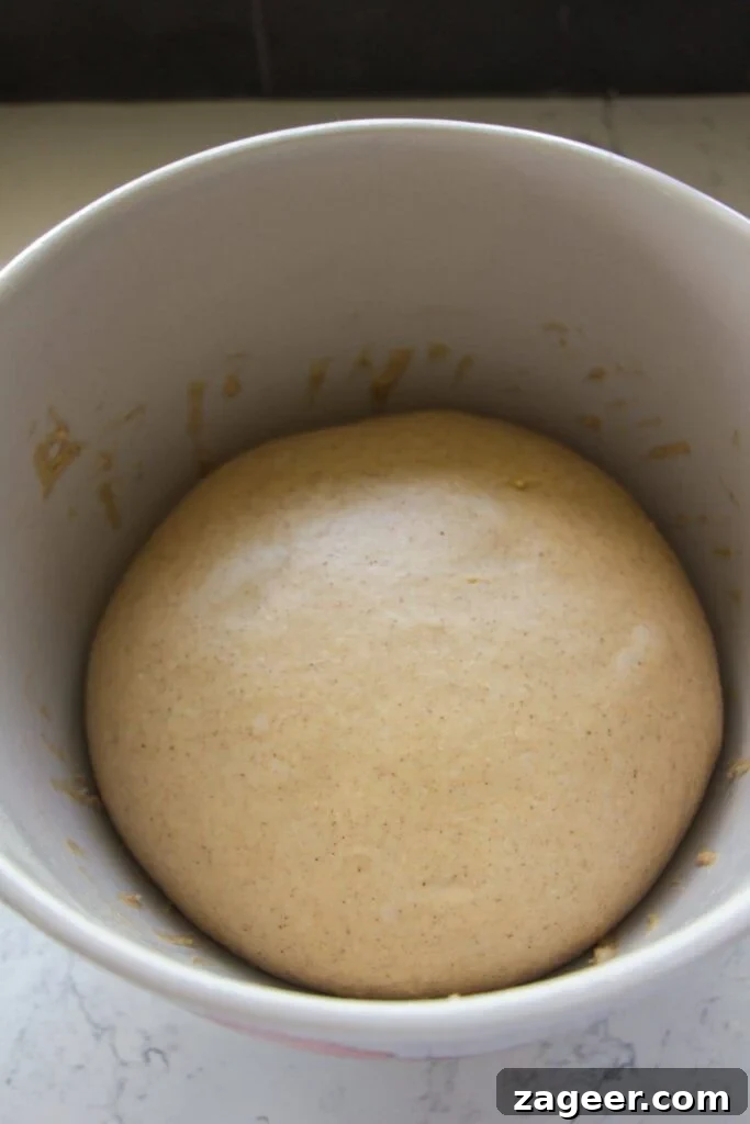 Easter Mini Egg Chocolate Hot Cross Buns 5 Hot cross bun dough after rising in a large white bowl.