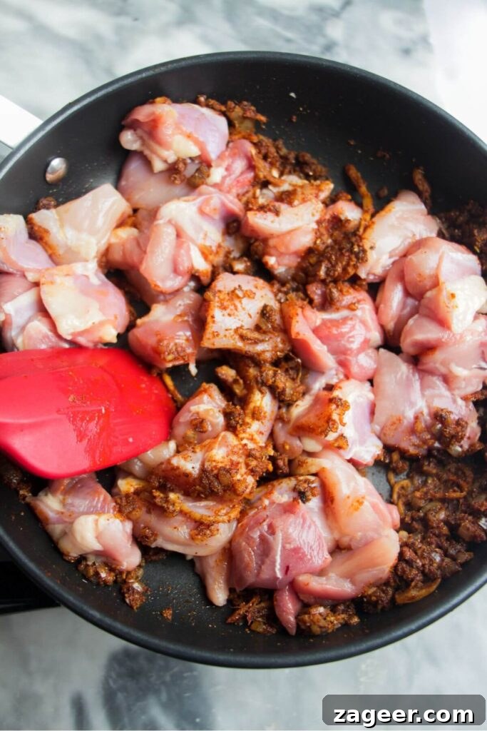 Speedy Chicken Rogan Josh 5 Diced chicken pieces coated in fragrant spices, lightly browned in a frying pan before liquids are added.