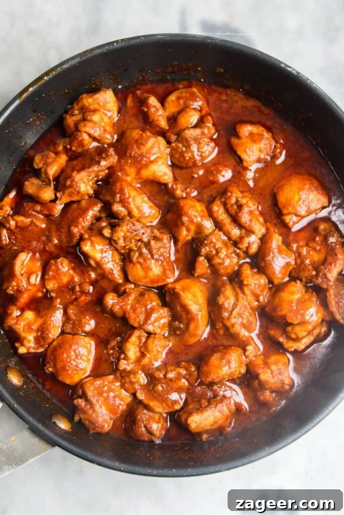 Speedy Chicken Rogan Josh 7 Chicken Rogan Josh thickening beautifully in a small frying pan, releasing its rich aromas as the sauce reduces.