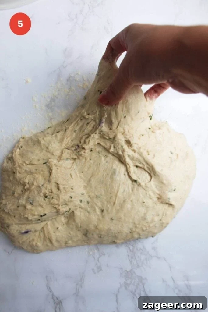 Artisan Style Rosemary Parmesan Bread Done Easy 8 Hand stretching rosemary parmesan bread dough.