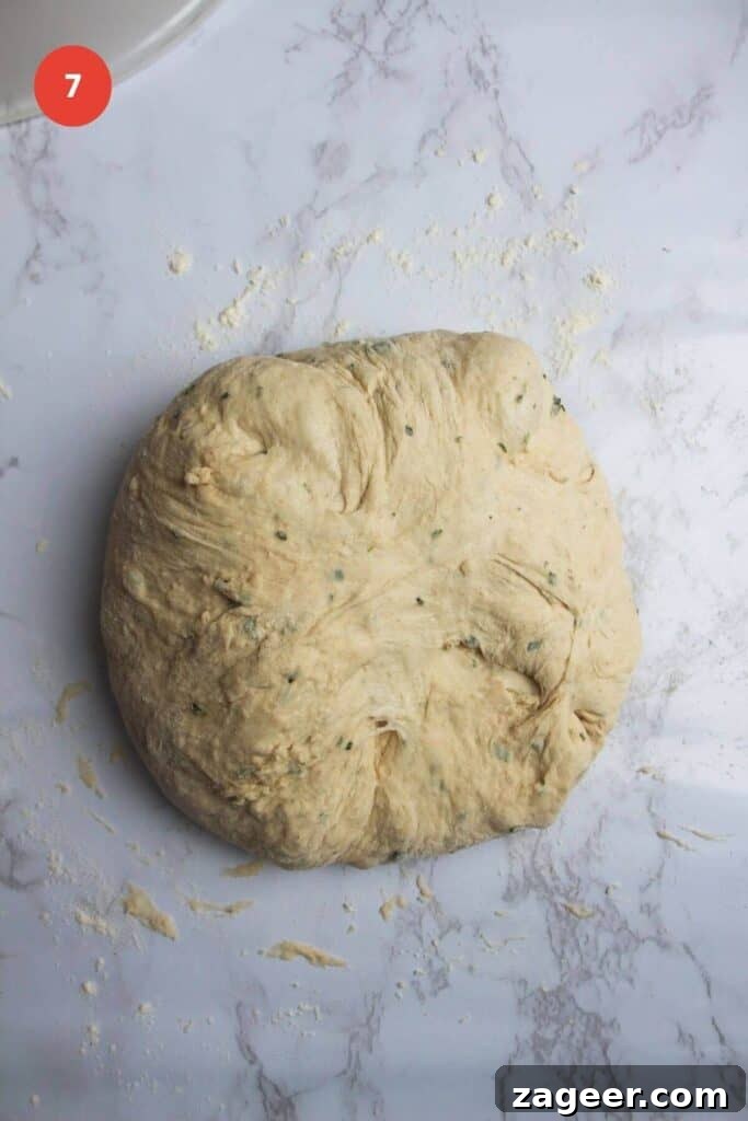 Artisan Style Rosemary Parmesan Bread Done Easy 10 Rosemary parmesan bread dough shaped on parchment paper.