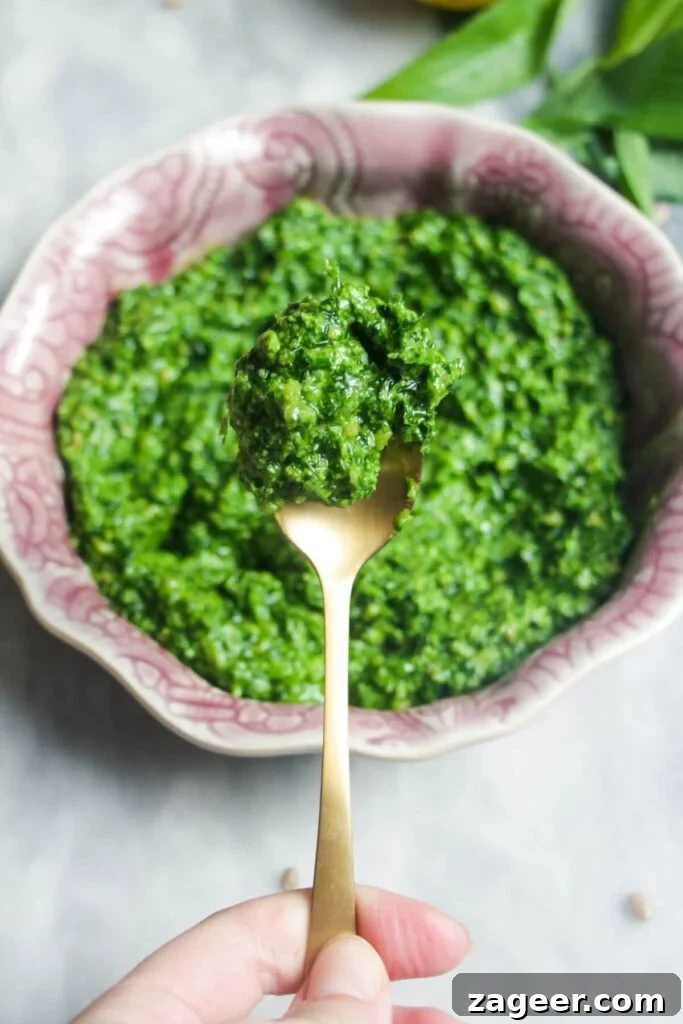 Wild Garlic Pesto in 5 Minutes 7 Close up of wild garlic pesto on a small gold spoon.