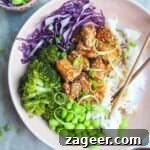 Glossy chicken teriyaki on top of rice with red cabbage, edamame and broccoli.