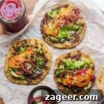 Three perfectly assembled Big Mac tacos presented on a rustic wooden board, garnished with fresh pickles and a generous drizzle of homemade Big Mac sauce. A vibrant and appealing image that captures the essence of this popular TikTok trend.
