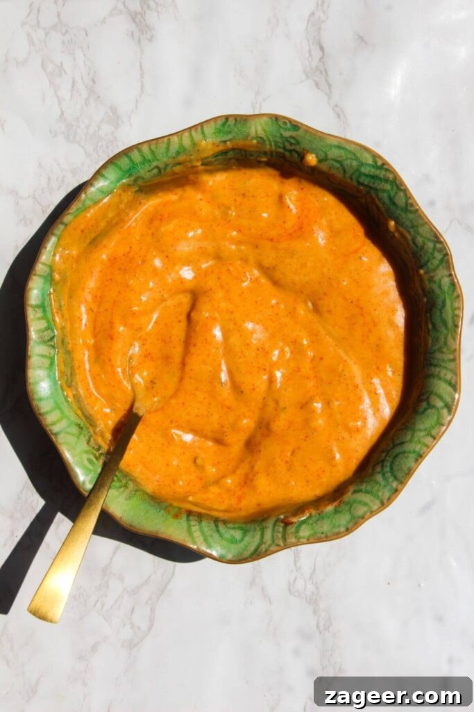 Big Mac Smash Burger Taco Fusion 4 Homemade Big Mac sauce, a creamy orange blend, mixed in a small green ceramic bowl, ready to be drizzled over the tacos.