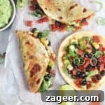 3 chorizo black bean tacos on a baking paper lined board, with whipped avocado and salsa on the side.