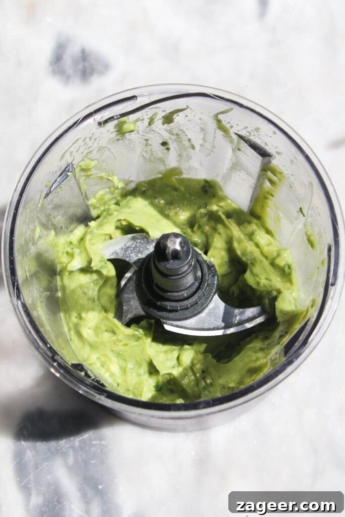 Spicy Chorizo and Black Bean Tacos with Sweet Pineapple Salsa 4 Creamy whipped avocado being processed in a small, compact food processor.
