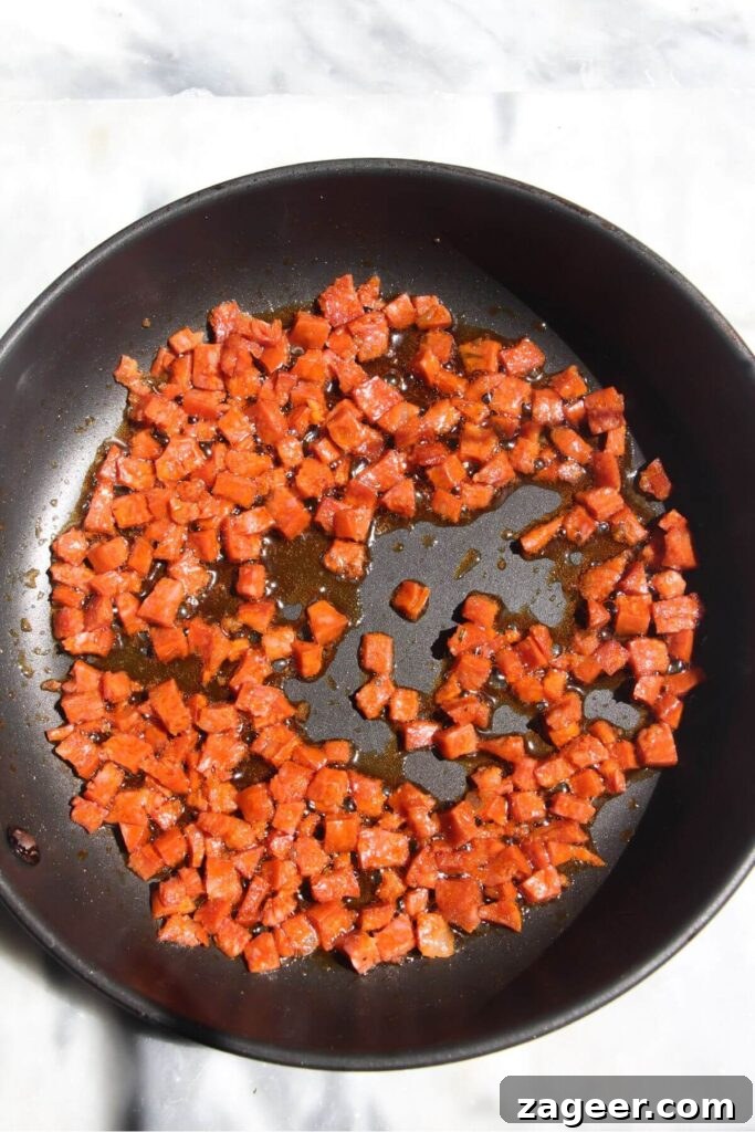 Spicy Chorizo and Black Bean Tacos with Sweet Pineapple Salsa 6 Finely diced chorizo sizzling in a small black non-stick pan, beginning to crisp up.