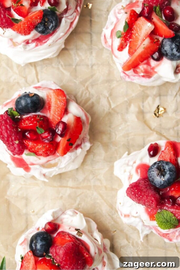 Heavenly Berry Ripple Cheesecake Pavlova Bites 20 Close up of mini berry ripple cheesecake pavlovas topped with berries.