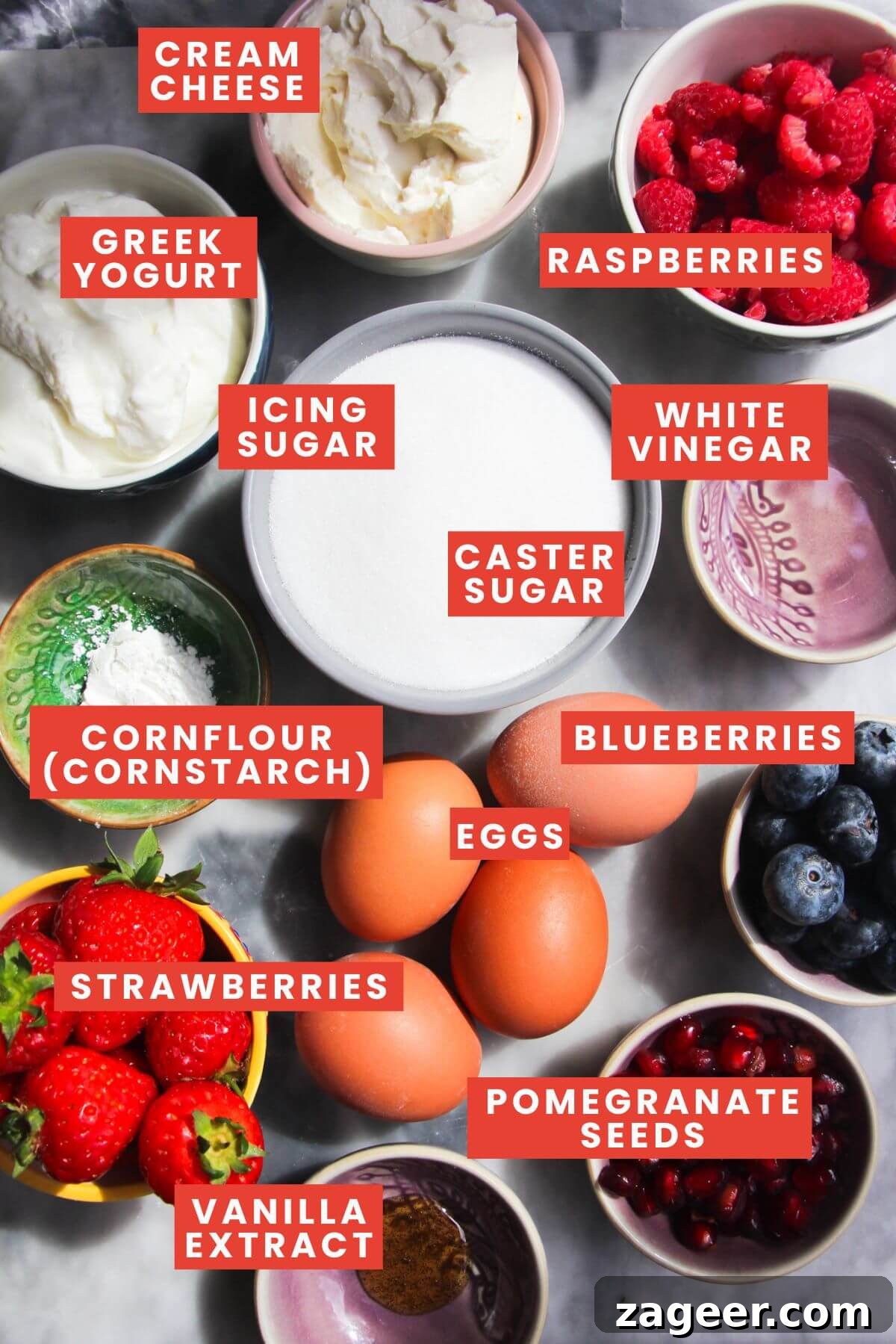 Heavenly Berry Ripple Cheesecake Pavlova Bites 3 Ingredients for mini pavlovas laid out on a grey marble background and labelled.