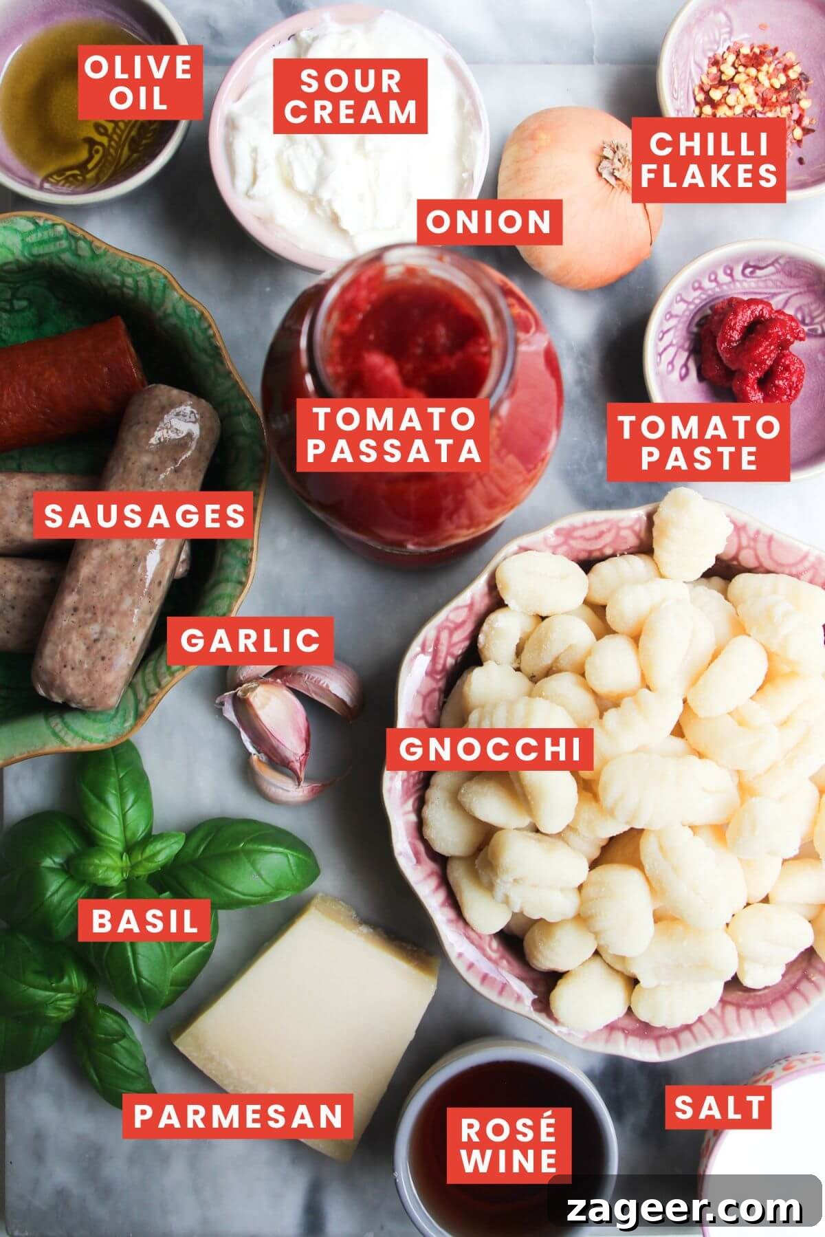 Creamy One-Pot Sausage Gnocchi Delight 3 A collection of fresh ingredients for sausage gnocchi, including gnocchi, sausages, tomatoes, and herbs, neatly arranged on a wooden countertop with clear labels for easy identification.
