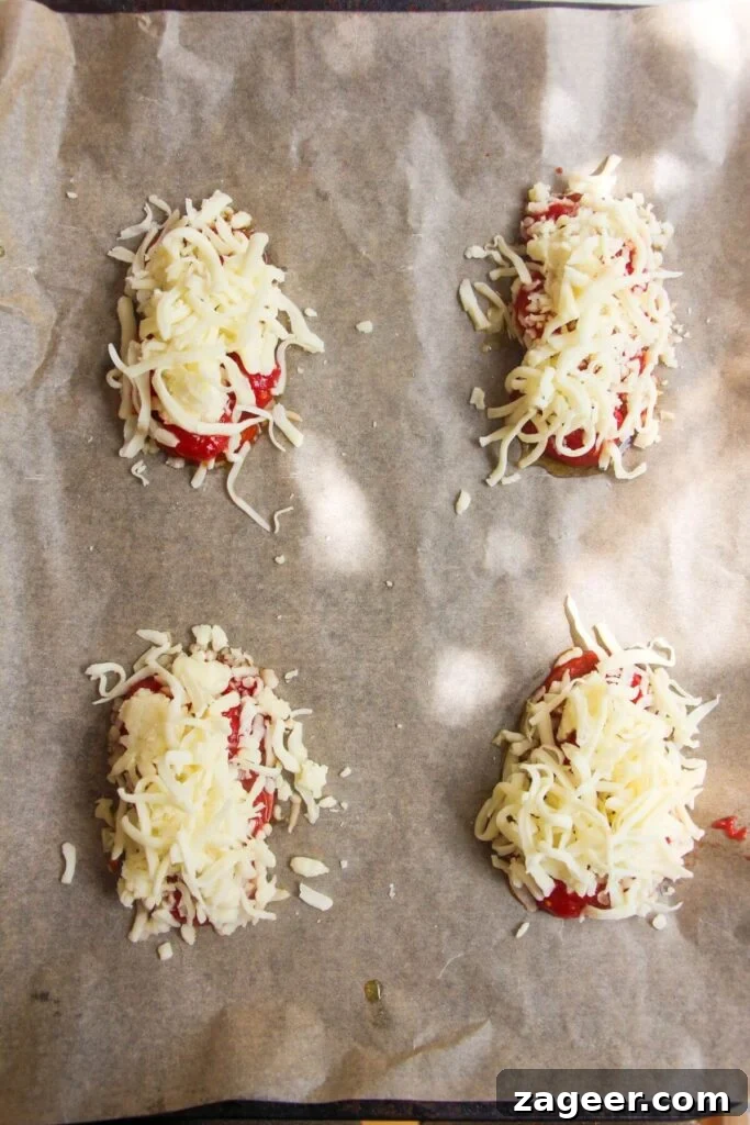 Puff Pastry Pizza Flips 6 A generous layer of grated mozzarella scattered over the tomatoes, pepperoni, and garlic on a lined baking tray, promising a melty, cheesy center.