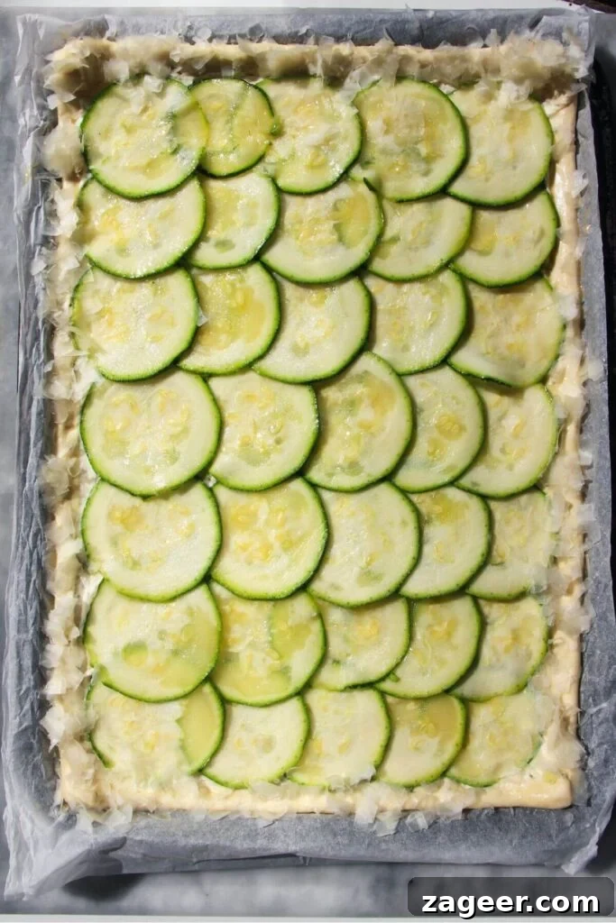 Golden Zucchini Puff Pastry Tart 6 Delicate, thinly sliced zucchini layered artistically over the Boursin base on puff pastry, with grated Parmesan sprinkled on the crust.
