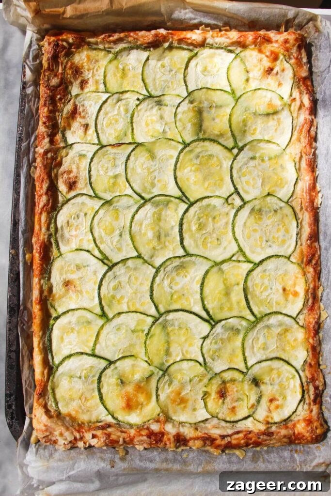 Golden Zucchini Puff Pastry Tart 7 The Zucchini Puff Pastry Tart, freshly baked to a golden crisp, resting on a lined oven tray, ready for its final touches.