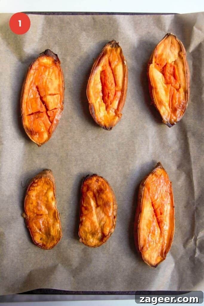 Effortless 5-Ingredient Sweet Potato Gnocchi 4 Roasted sweet potato halves on a lined oven tray.