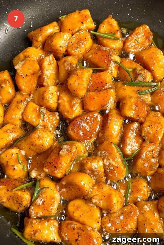 Effortless 5-Ingredient Sweet Potato Gnocchi 10 Sweet potato gnocchi in brown butter sauce in a pan.