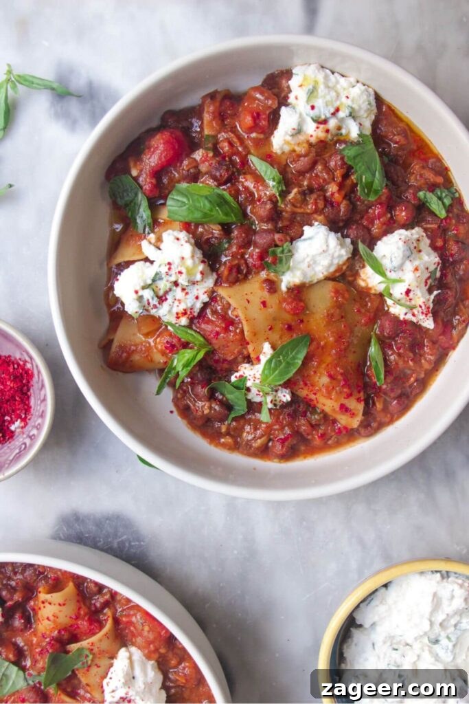 Stealthy Veggie One Pot Lasagna Soup 12 Two bowls of vegetarian lasagna soup, beautifully plated with ricotta and basil.