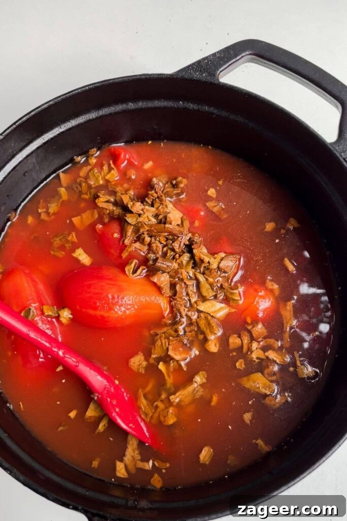 Stealthy Veggie One Pot Lasagna Soup 5 Tomatoes, beans, mushrooms and stock added to lasagna soup pot, creating a rich base.