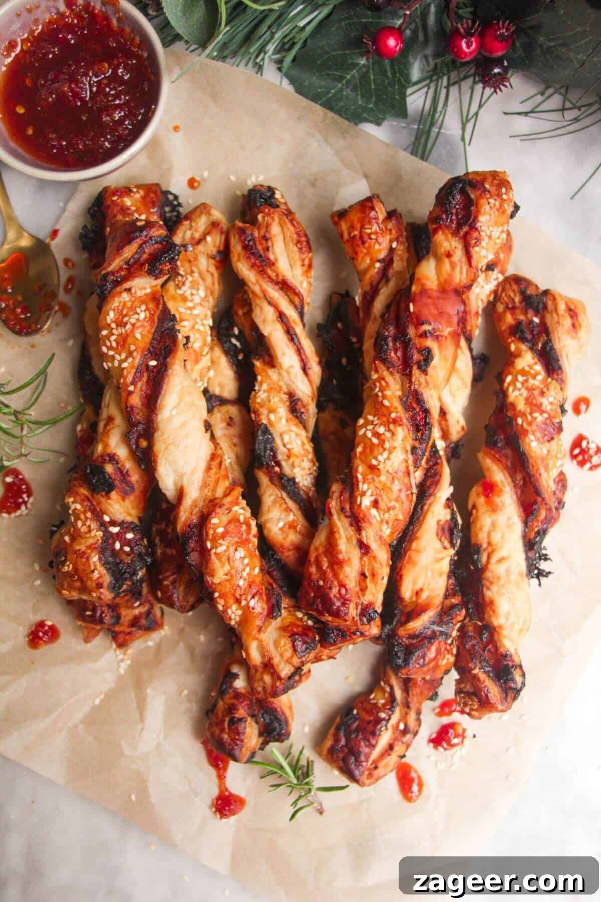 A pile of golden-brown bacon, blue cheese, and sweet chilli twists on a sheet of baking paper, ready to be served as a gourmet appetizer.