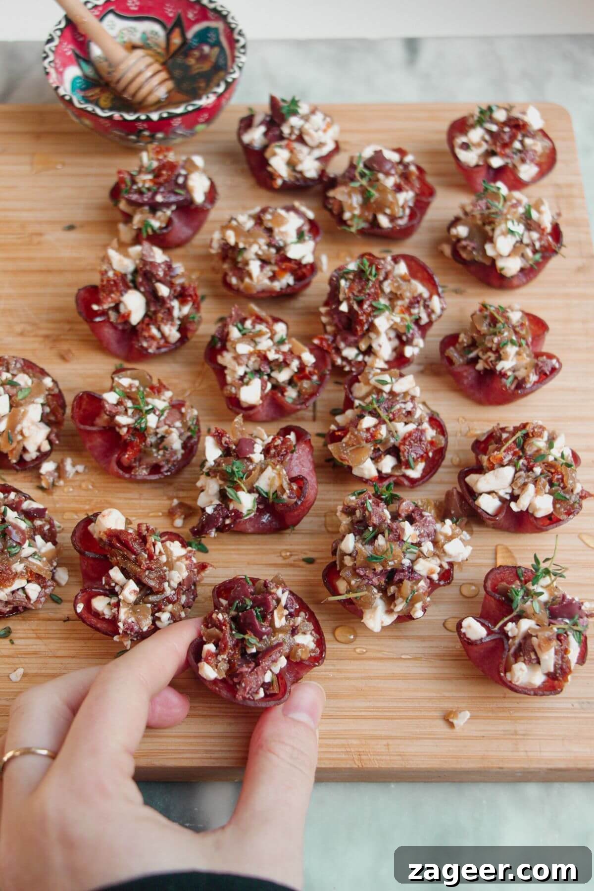 Loaded Antipasto Salami Crisps 2 Loaded crispy salami bites arranged beautifully on a rustic wooden board.