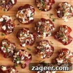 Loaded crispy salami bites on a wooden board.