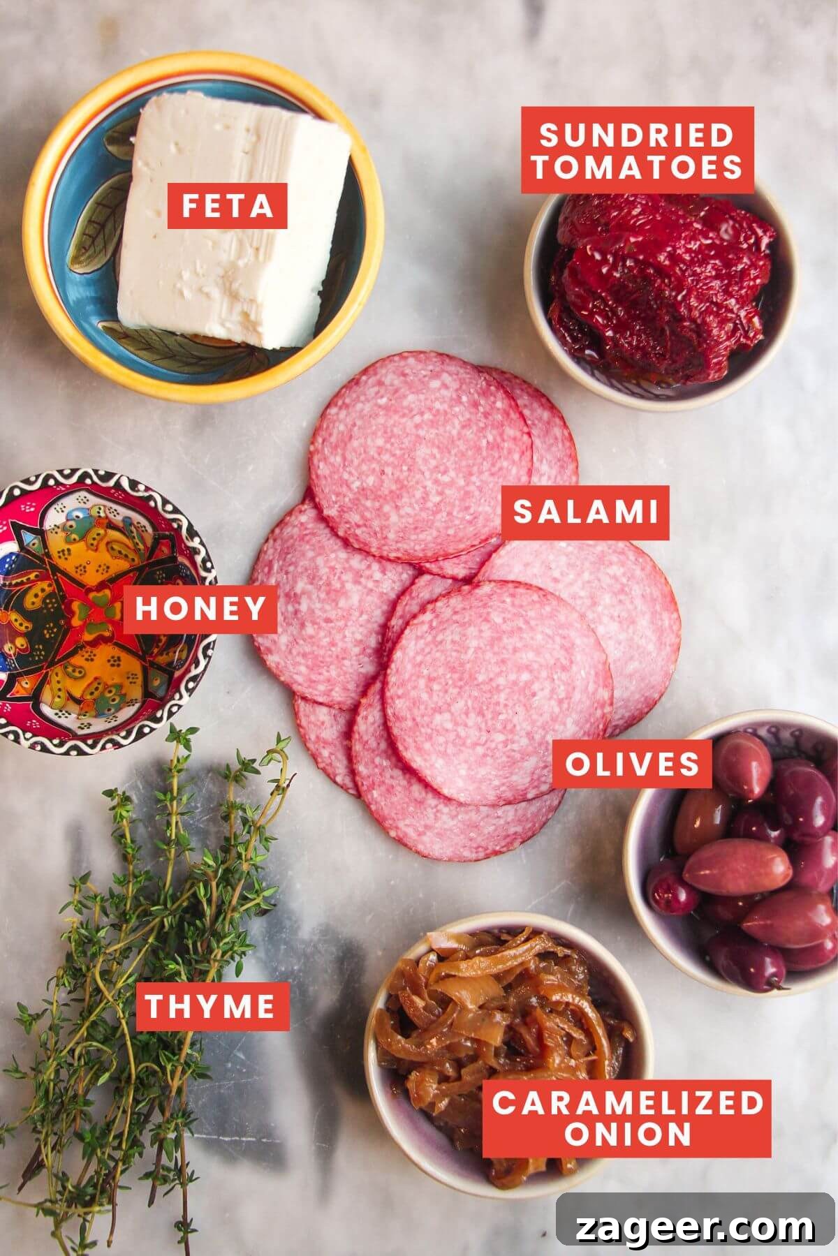 Loaded Antipasto Salami Crisps 3 All ingredients for salami bites, neatly organized and labeled on a pristine marble surface.
