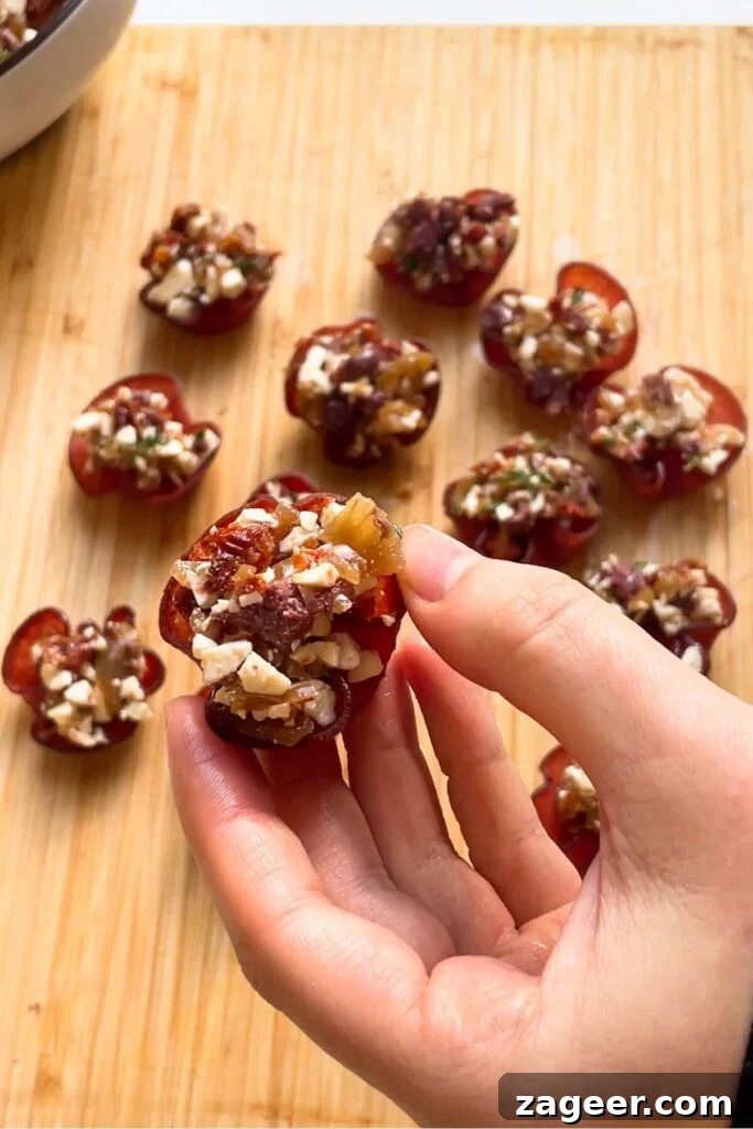 Loaded Antipasto Salami Crisps 9 A hand holding a perfectly assembled and filled crispy salami bite, ready to be enjoyed.