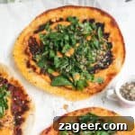 Smash lahmacun taco with red pepper sauce and herby salad on top, featured in the recipe card.