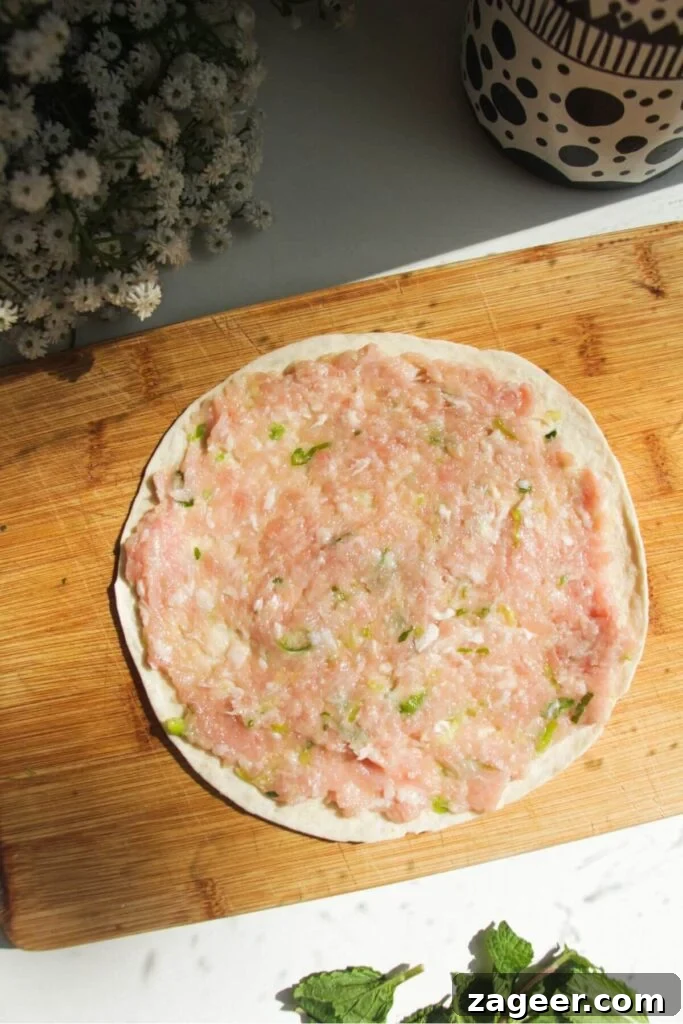 Smashed Banh Mi Tacos 5 The chicken mixture being spread thinly onto a mini tortilla before cooking.
