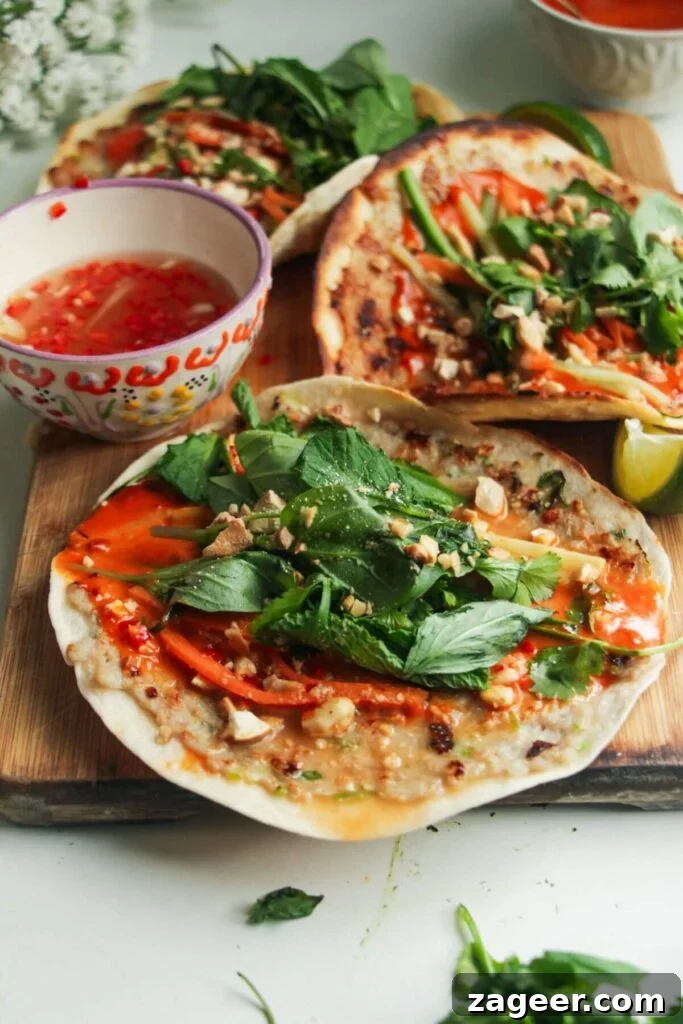 Smashed Banh Mi Tacos 8 Three fully assembled chicken banh mi tacos presented on a wooden board, ready to eat.