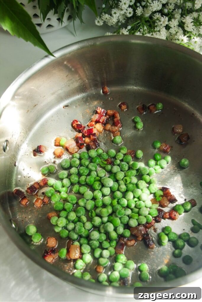 Silky Pancetta, Pea, and Spinach Pasta 6 Crispy diced pancetta and bright green peas sizzling in a silver pan, creating an aromatic base for the pasta.
