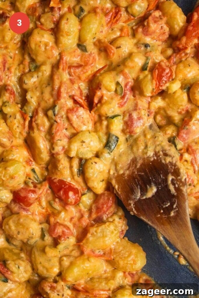 One Pan Creamy Boursin Gnocchi Bake 6 Gnocchi mixed through a creamy tomato Boursin sauce in a baking dish.