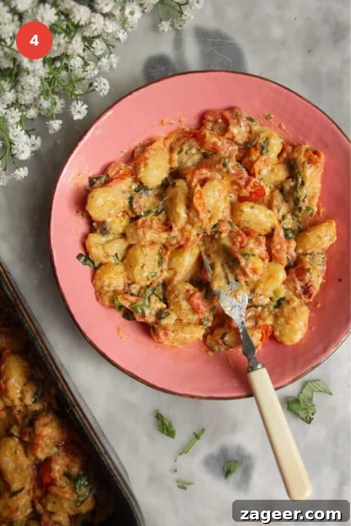 One Pan Creamy Boursin Gnocchi Bake 7 Creamy gnocchi served in a bowl with the baking dish on the side.