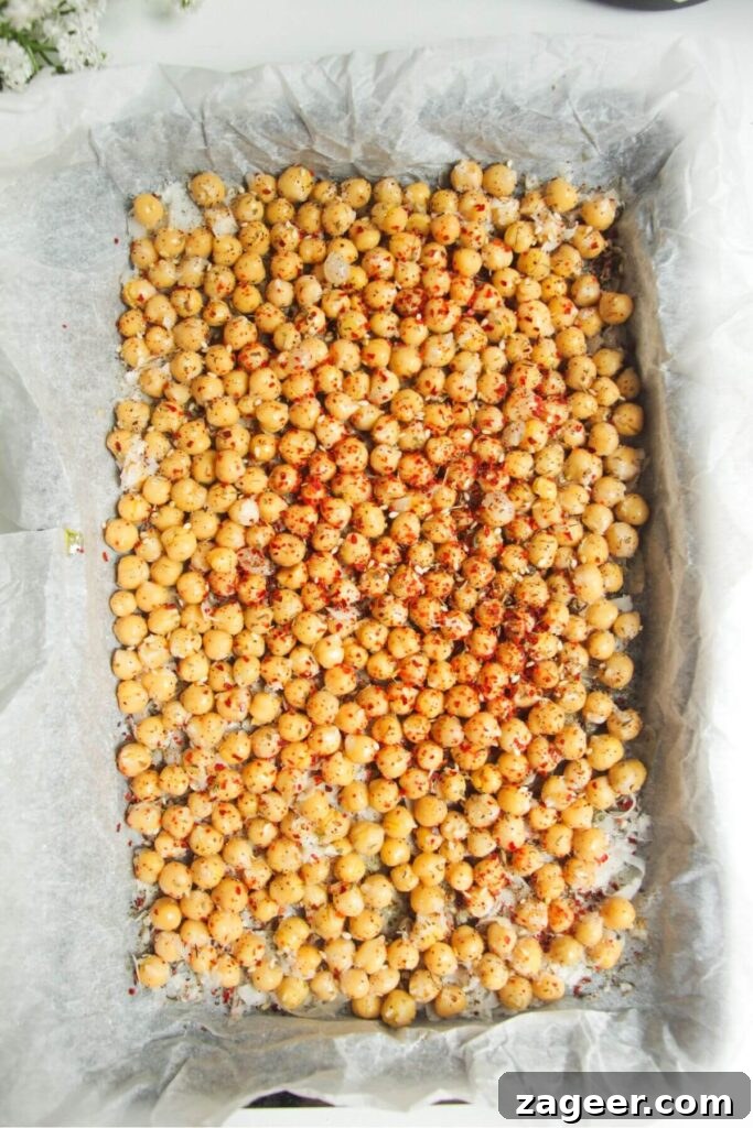 Chicken Caesar Crispy Rice Power Bowl 6 Seasoned chickpeas on a baking tray, ready to be crisped in the oven.