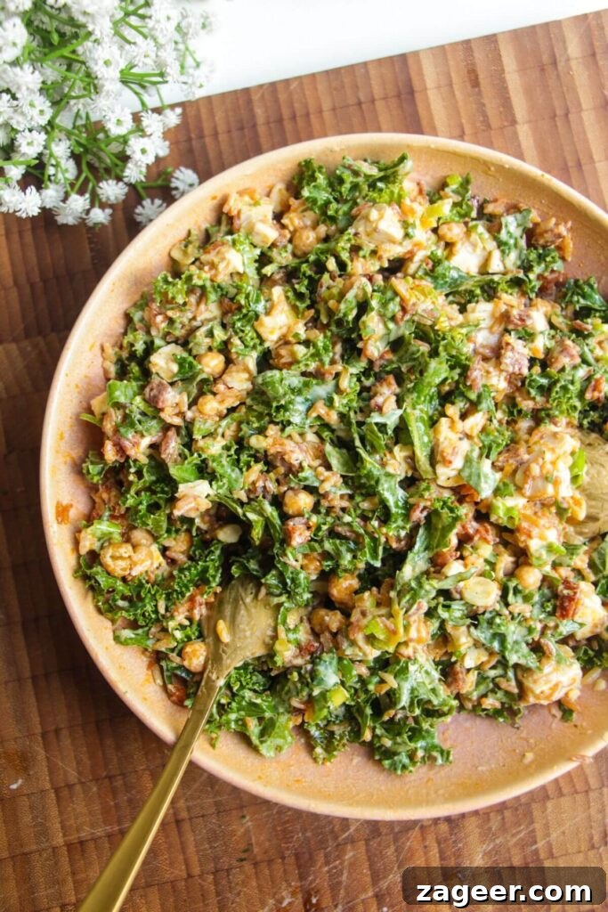 Chicken Caesar Crispy Rice Power Bowl 10 The chicken Caesar rice salad, fully mixed and vibrant, presented in a large serving bowl.