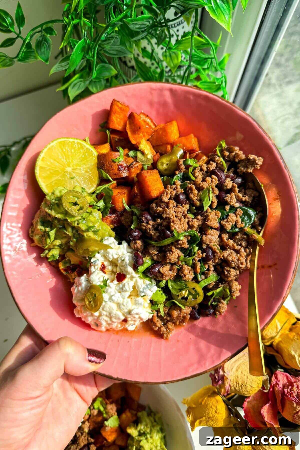 Trending Beef Power Bowls with Sweet Potato & Creamy Cottage Cheese 2 Holding a vibrant, freshly assembled viral cottage cheese beef bowl, showcasing layers of taco beef, sweet potato, avocado, and cottage cheese.