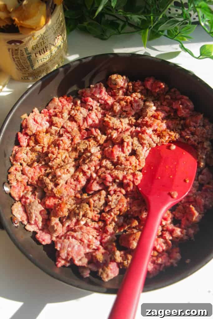 Trending Beef Power Bowls with Sweet Potato & Creamy Cottage Cheese 7 Ground beef being added to a hot pan with spices.