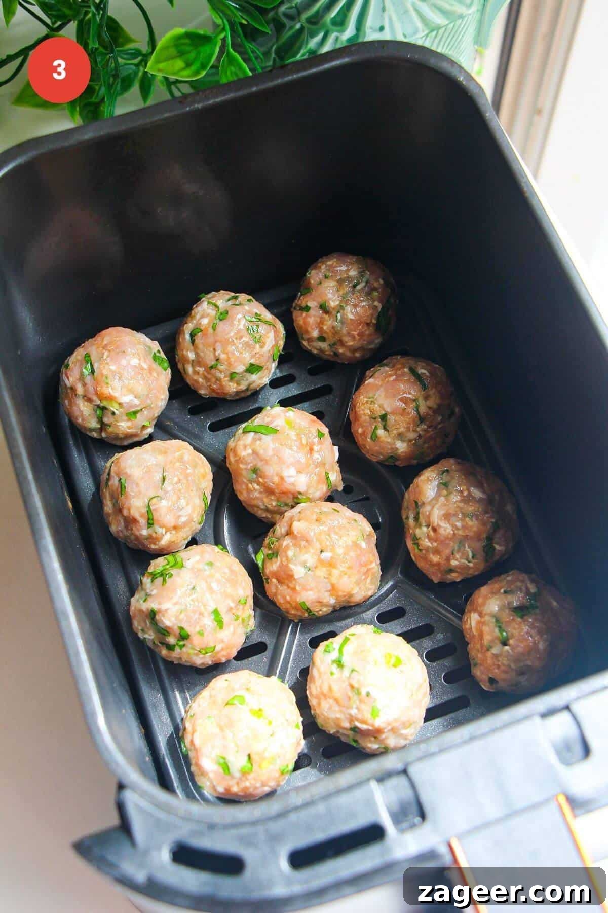 Creamy Gochujang Dumpling Meatballs 6 Rolled dumpling meatballs in air fryer basket.