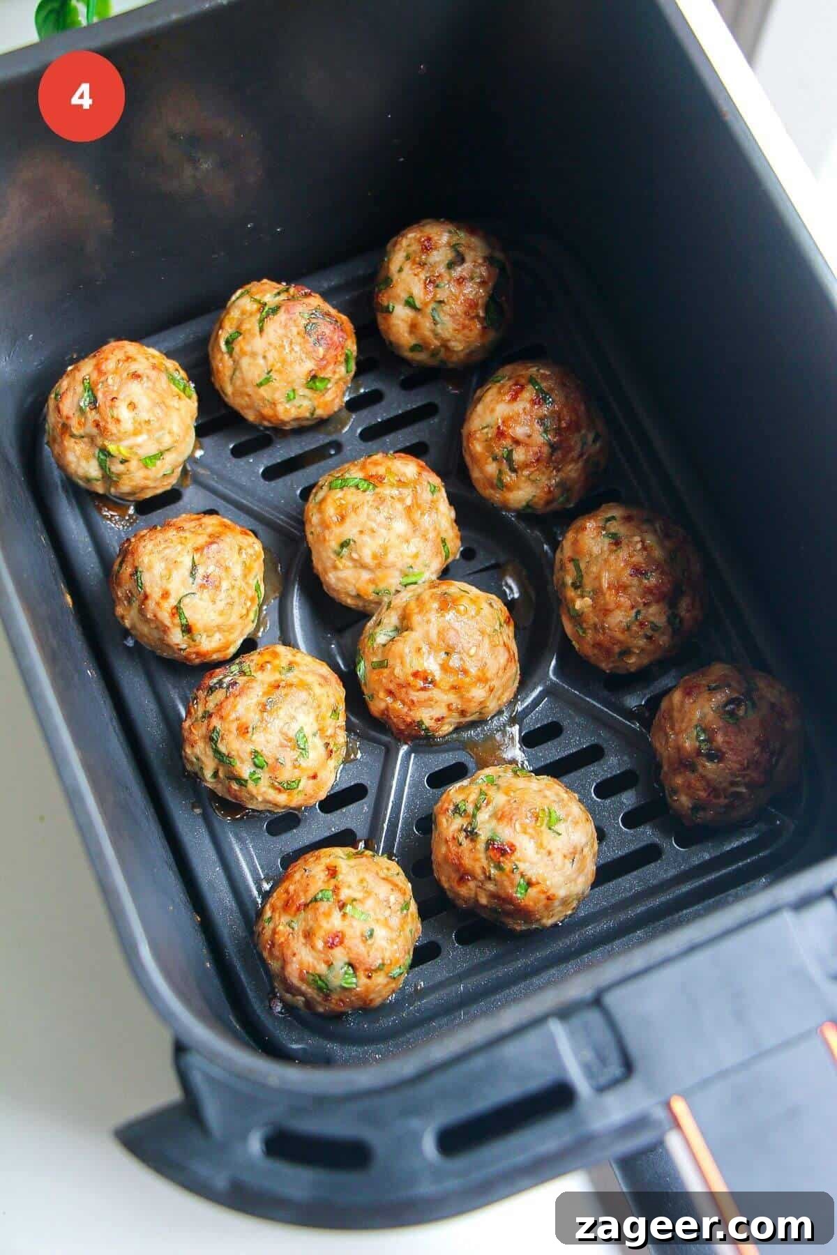 Creamy Gochujang Dumpling Meatballs 7 Cooked dumpling meatballs in air fryer basket.