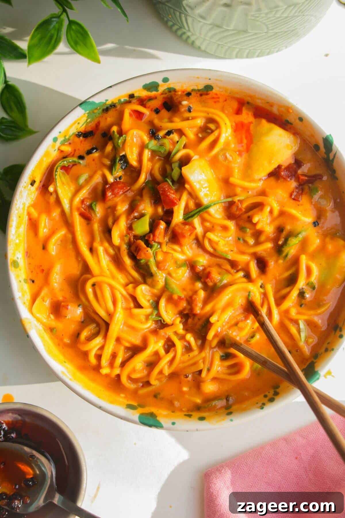 Velvety One-Pot Coconut Butternut Ramen 14 Butternut noodles in a bowl, with chopsticks.