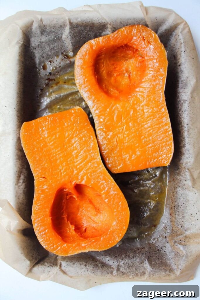 Velvety One-Pot Coconut Butternut Ramen 4 Soft roasted squash on a lined oven tray.